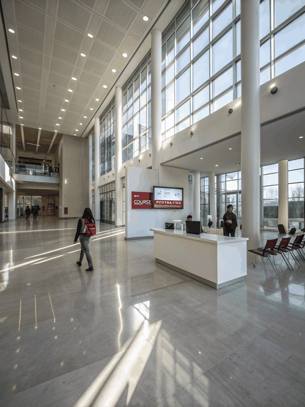 Students walking in bright campus interior hall