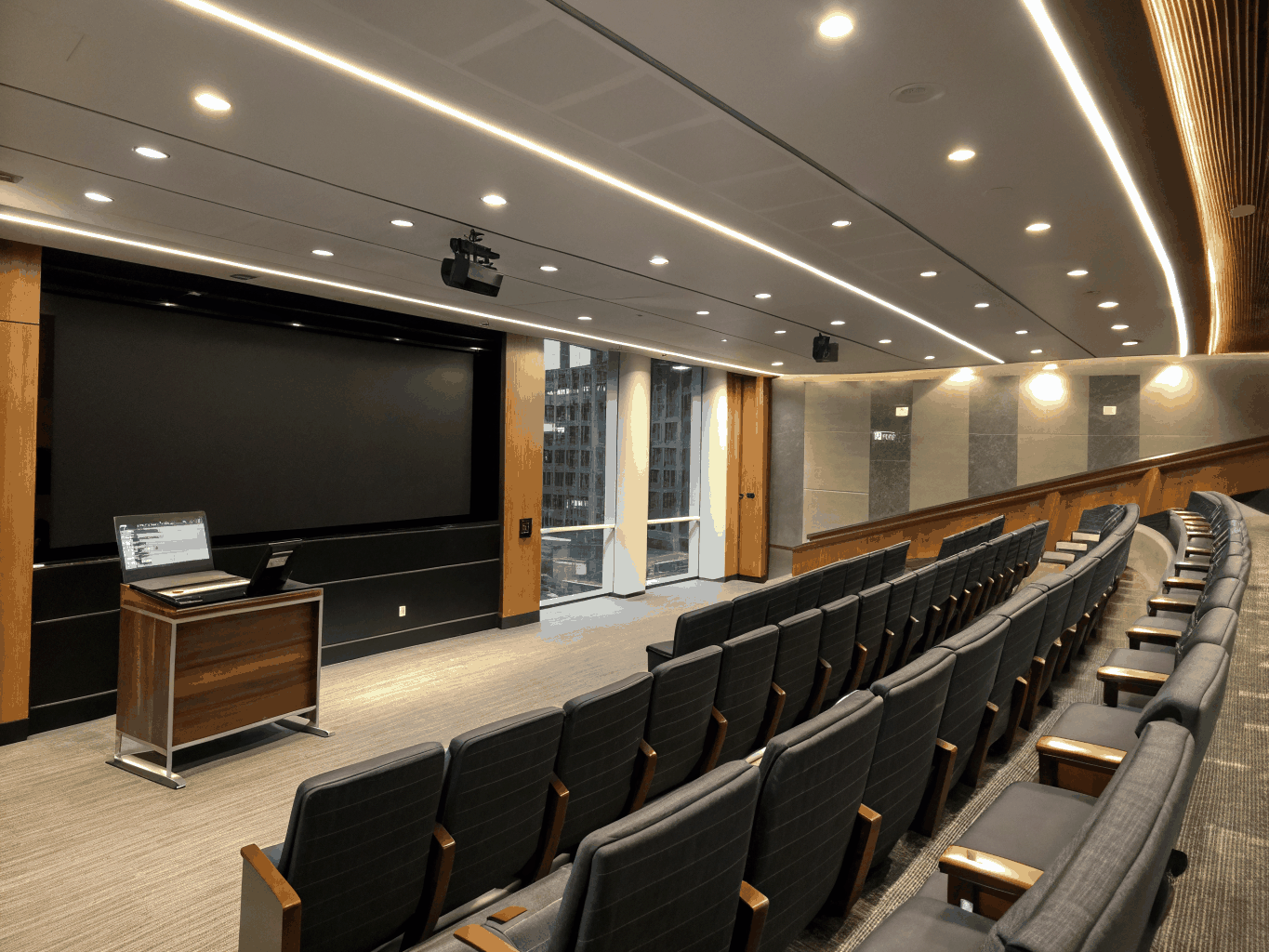 Modern lecture hall with tiered seating and advanced AV equipment